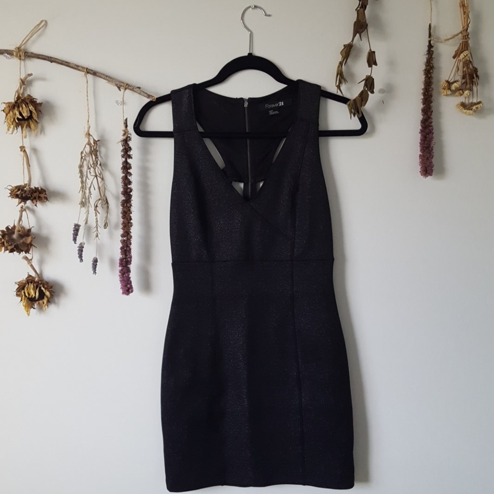 Low cut black sparkly dress with back cut-outs